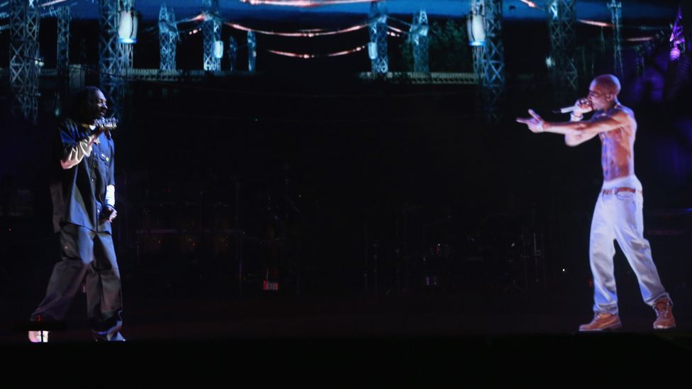 The Coachella Festival saw long-dead rapper Tupac Shakur appear as a 3D hologram (right) – meaning deceased stars may still be able to tour. (Copyright: Getty Images/Coachella) The Coachella Festival saw long-dead rapper Tupac Shakur appear as a 3D hologram (right) – meaning deceased stars may still be able to tour. (Copyright: Getty Images/Coachella)