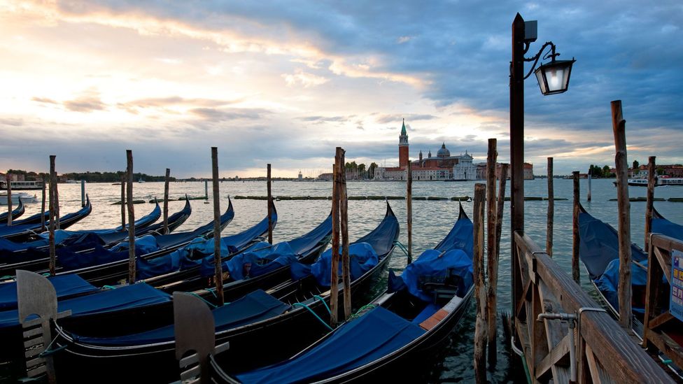 The gondolas bob on the water as the sun sets over Venice. (Pete Seaward)