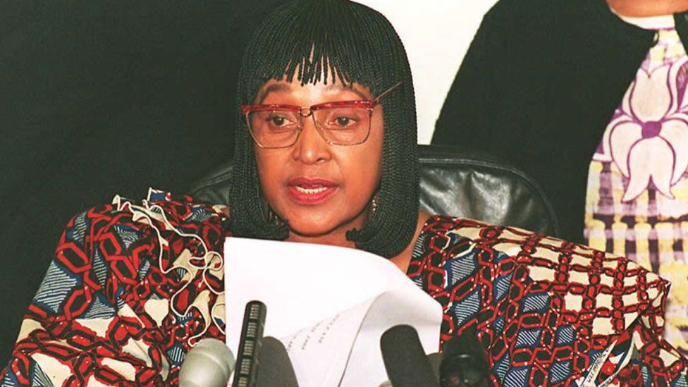 Reading a statement at a press conference to announce her resignation as minister in 1995. Madikizela-Mandela adopted a wild array of accessories during this period. (Getty Images)