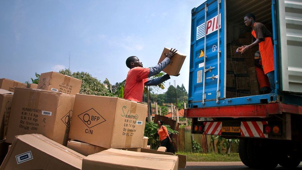 At Barefoot Power’s office in Kampala, Uganda, employees help unload a container of products from China, via Nairobi, including lights and power packs. At Barefoot Power’s office in Kampala, Uganda, employees help unload a container of products from China, via Nairobi, including lights and power packs.
