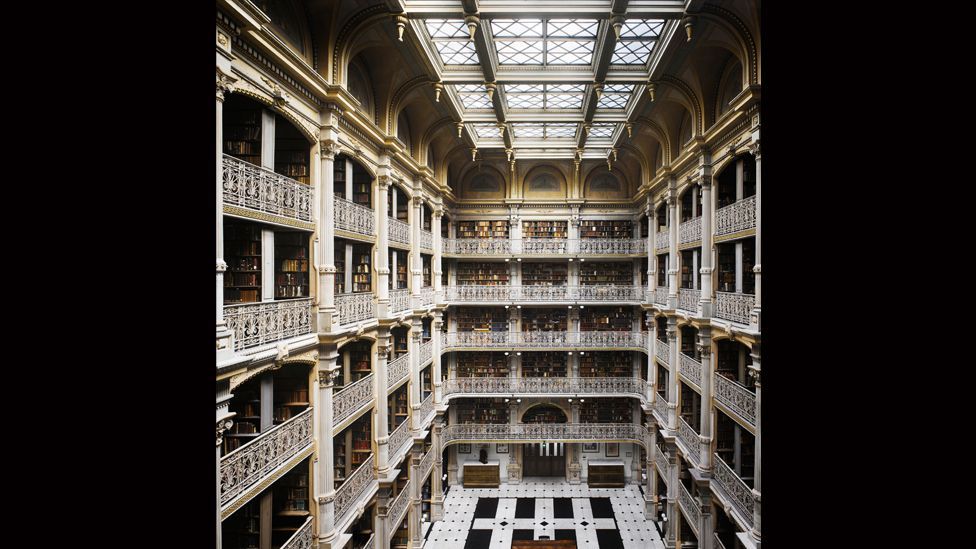 A skylight soars over five cast-iron ornamental balconies in the George Peabody Library at Johns Hopkins University in Baltimore. A skylight soars over five cast-iron ornamental balconies in the George Peabody Library at Johns Hopkins University in Baltimore.