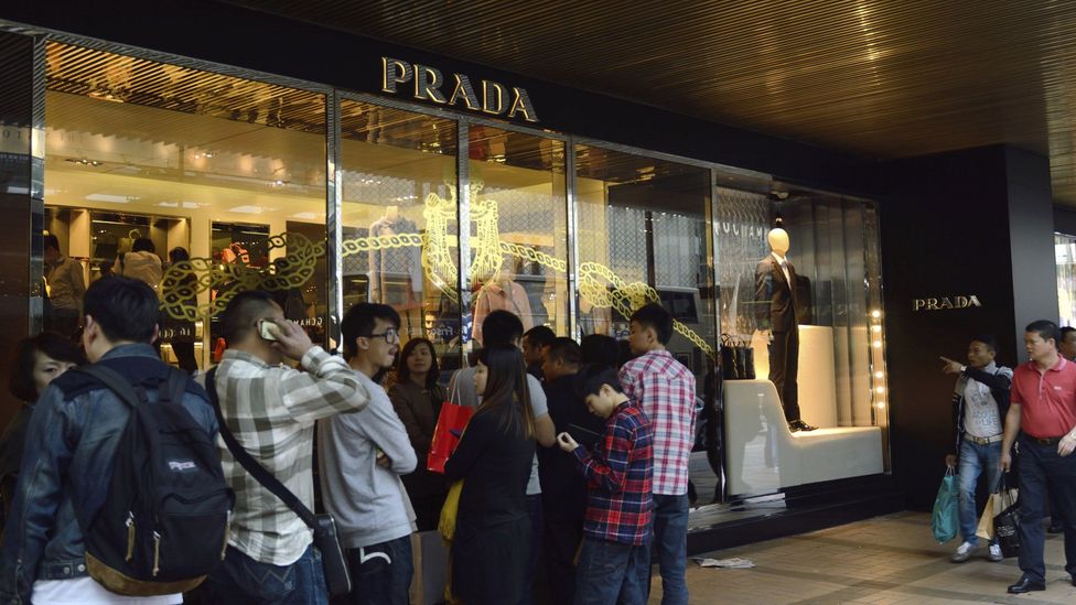 A traveler passes a Louis Vuitton store at Hong Kong International News  Photo - Getty Images