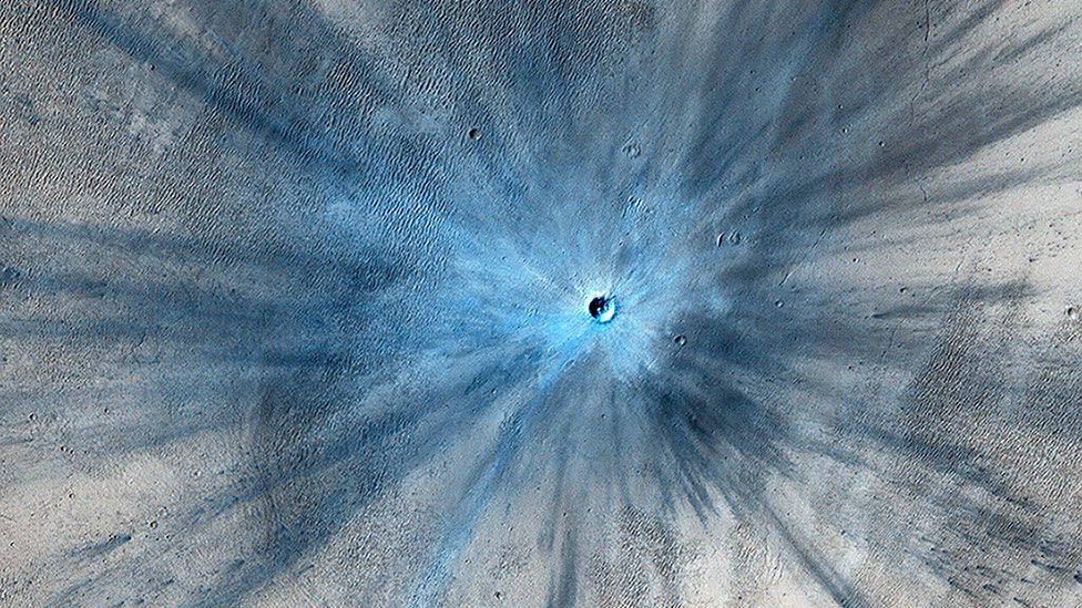 A crater on Mars, approximately 100 feet (30m) deep, and surrounded by a blast zone. Imaging technology has made the freshly-made crater look blue. (Nasa/JPL-Caltech/Reuters) A crater on Mars, approximately 100 feet (30m) deep, and surrounded by a blast zone. Imaging technology has made the freshly-made crater look blue. (Nasa/JPL-Caltech/Reuters)