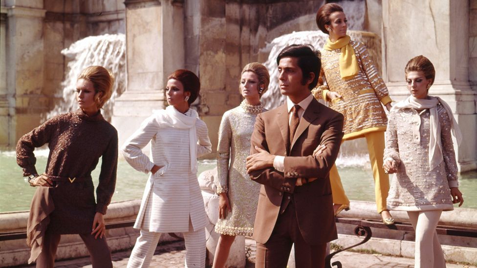 Designer Valentino poses with Italian swagger alongside models wearing his designs in Rome, 1967. (Courtesy Art Archive/Mondadori Portfolio/Marisa Rastellini)