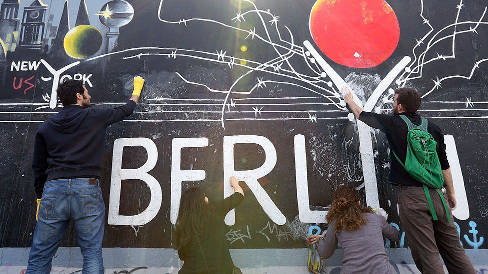 Volunteers maintain the murals of Berlin's East Side Gallery. (Adam Berry/Getty Images)
