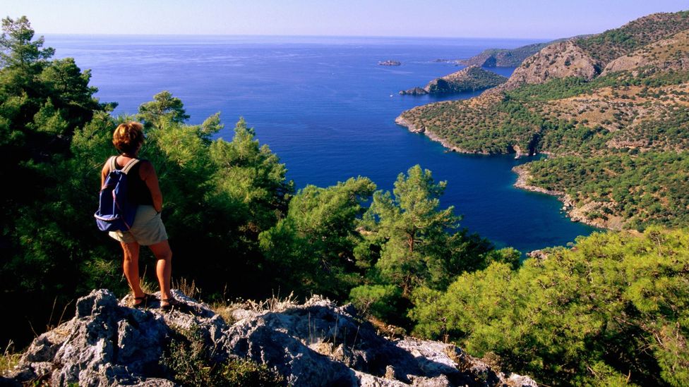 A hiker climbs the coastline between Kayakoy and Oludeniz. (John Elk III/Getty) A hiker climbs the coastline between Kayakoy and Oludeniz. (John Elk III/Getty)