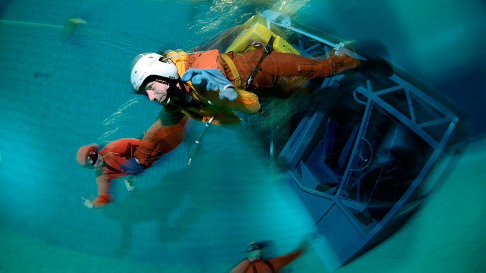 Breath-holding is part of the training for some jobs: a pilot practises escaping from a submerged aircraft cockpit in Brest, France. (Science Photo Library)