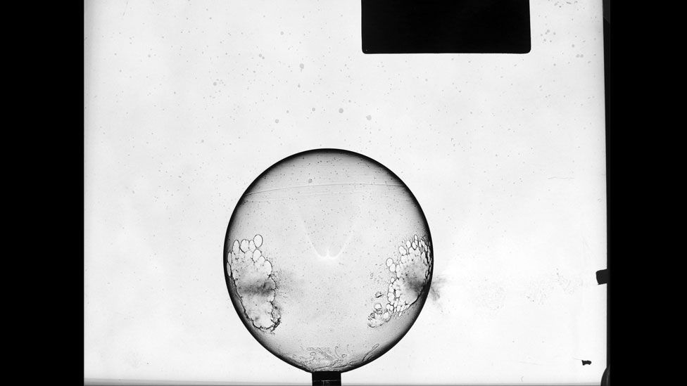 Here's a balloon punctured by a bullet, moments before it bursts. (Harold Edgerton Archive, MIT)