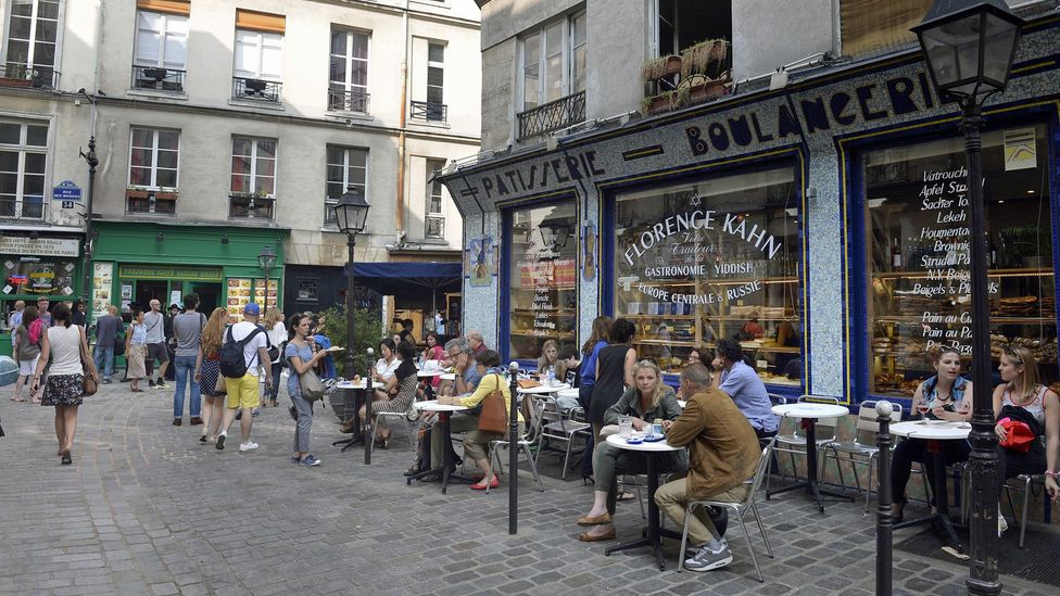 Visitors and locals relax outside a cafe in Paris' Marais. (Miguel Medina/AFP/Getty)