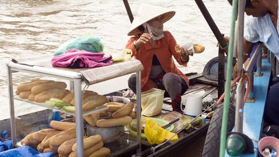 A banh mi vendor on a boat in Vietnam. (Jupiter Images/Getty) A banh mi vendor on a boat in Vietnam. (Jupiter Images/Getty)