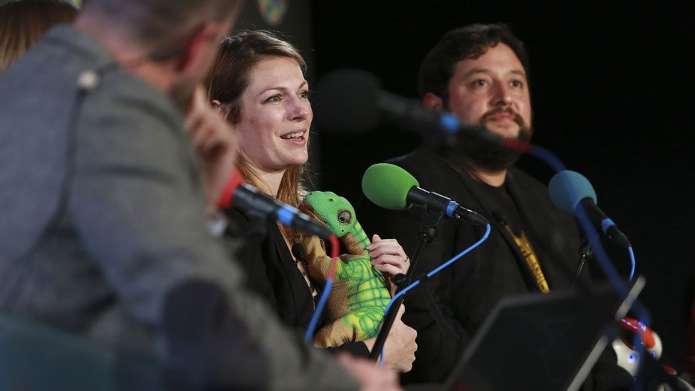 Kate Darling cradles her dinosaur robot at the World-Changing Ideas Summit (Amy Sussman/AP)