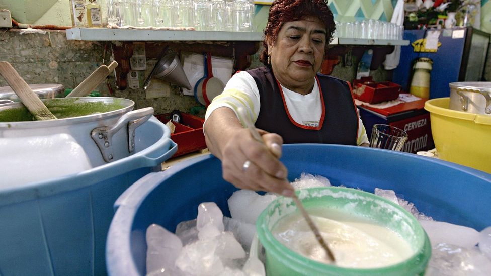 Stirring pulque in Mexico City. (Ronaldo Schemidt/AFP/Getty)