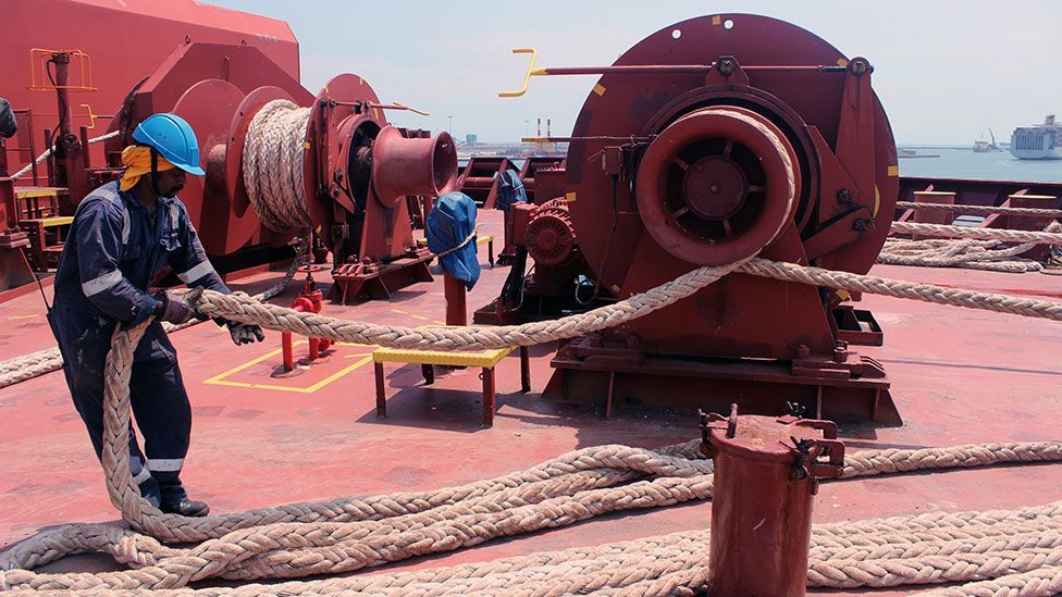 An Indian crew member of the Maersk Seletar lets out the bow rope before anchoring in Kaohsiung Port, Taiwan (Liam Young/Unknown Fields) An Indian crew member of the Maersk Seletar lets out the bow rope before anchoring in Kaohsiung Port, Taiwan (Liam Young/Unknown Fields)