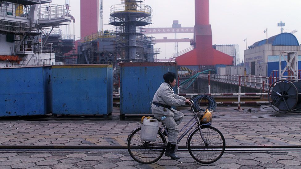Shipyard workers use bicycles to cover the vast territory of the construction site (Liam Young/Unknown Fields) Shipyard workers use bicycles to cover the vast territory of the construction site (Liam Young/Unknown Fields)