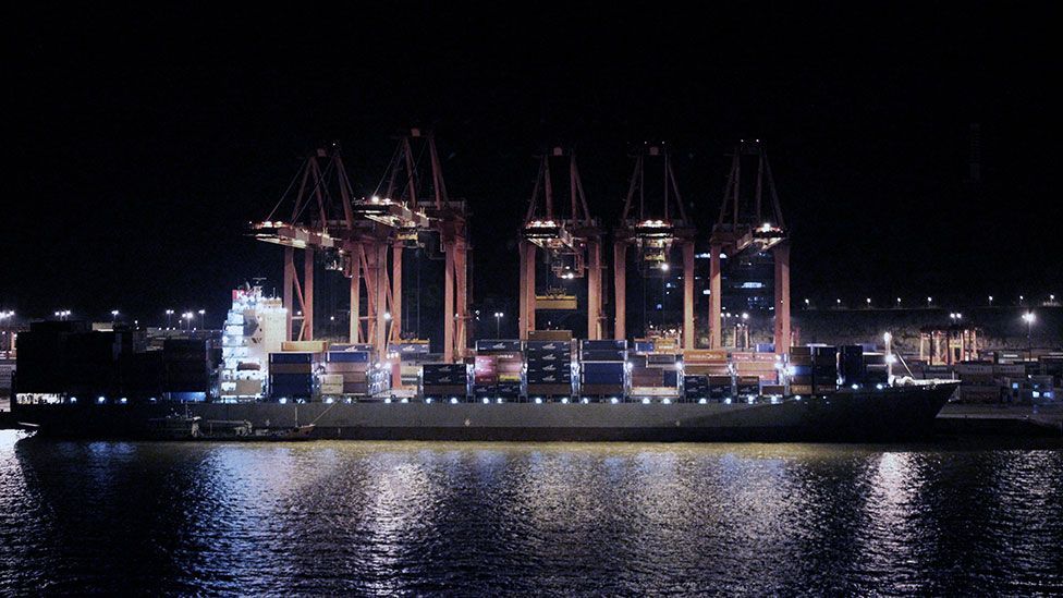A container ship is loaded by night in a Shanghai port (Liam Young/Unknown Fields) A container ship is loaded by night in a Shanghai port (Liam Young/Unknown Fields)