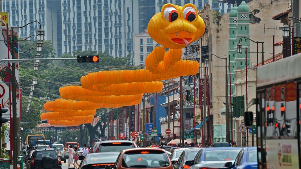 A snake shaped lantern figurine hangs above a road in Singapore (Credit: Roslan Rahman/AFP/Getty Images)