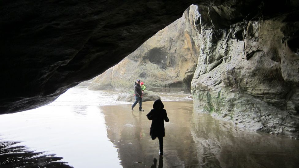 Exploring the caves at Hug Point park. (Credit: David G Allan) Exploring the caves at Hug Point park. (Credit: David G Allan)
