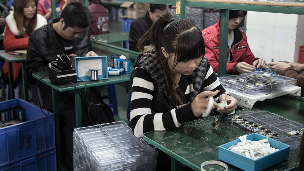 Workers in a factory in Shenzhen make MP3 players (Credit: Kate Davies/Unknown Fields)