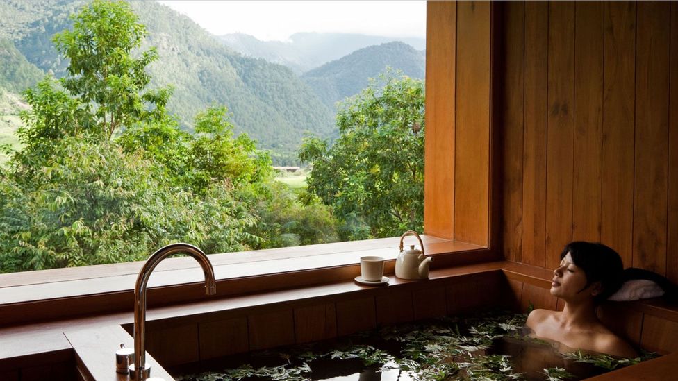 Unwinding in one of Bhutan's hot stone baths (Credit: Como Hotels and Resorts)