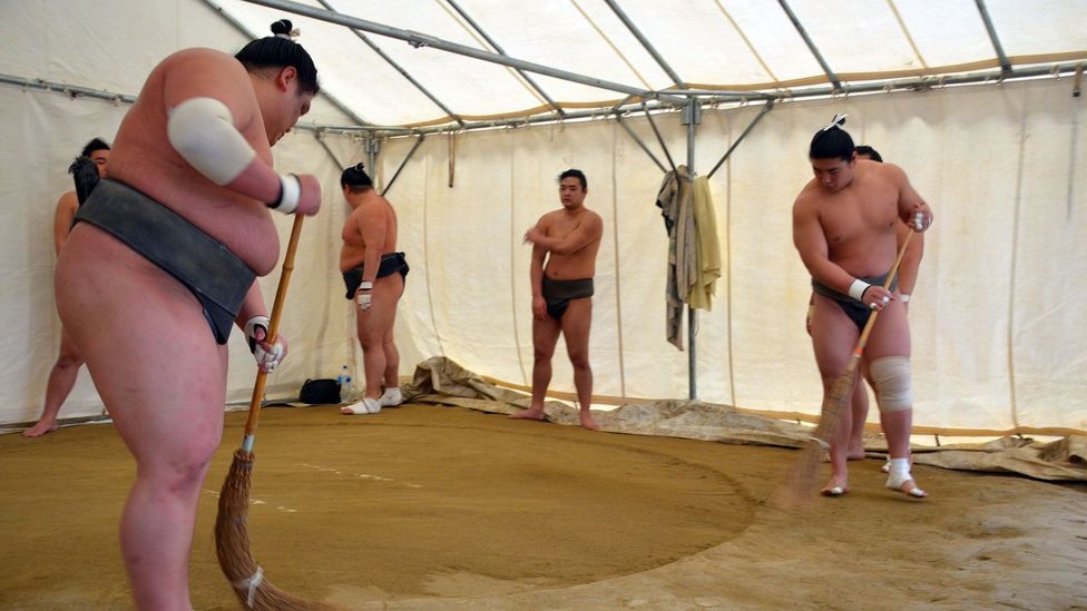 Preparing the dohyo before training (Credit: Matthew Bremner) Preparing the dohyo before training (Credit: Matthew Bremner)