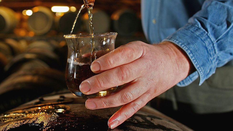 Taking a whisky sample from a cask at Bruichladdich (Credit: Jeff J Mitchell/Getty Images)