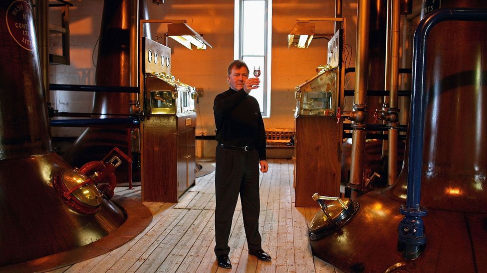 Jim McEwan of Bruichladdich holds a sample of the distillery's new quadruple distilled single malt (Credit: Jeff J Mitchell/Getty Images)