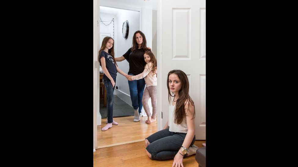Louise Hrela of Ireland with daughters Elizabeth, 13 and Grace, 7, along with their friend Scarlet (left), at home in London's Camden. (Credit: Chris Steele-Perkins/Magnum Photos)
