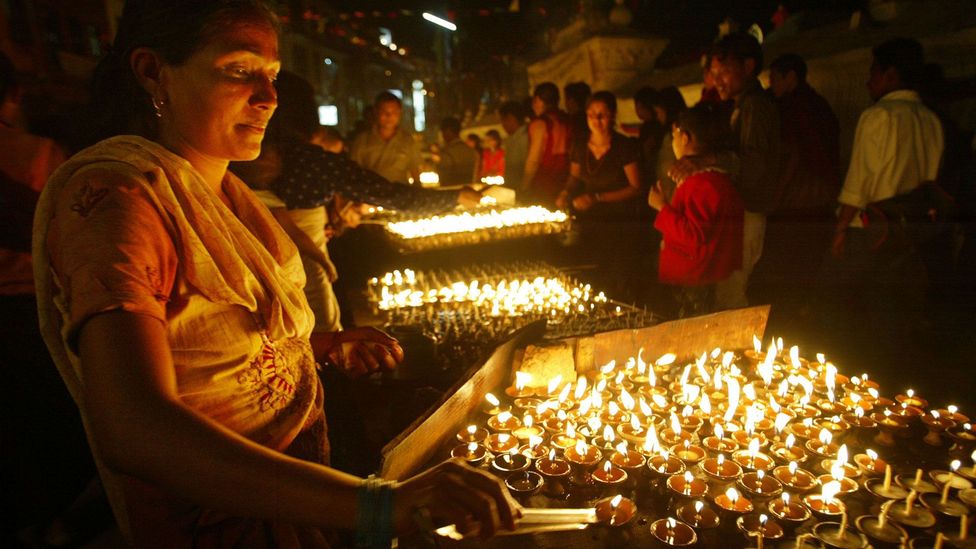 Lighting prayer candles for the Buddha's birthday (Credit: Paula Bronstein/Getty)