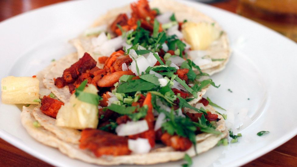 Chunks of pineapple sometimes top the al pastor taco (Credit: Darren & Justine/Tacos Al Pastor at Los Braseros/Flickr/CC BY-SA 2.0) Chunks of pineapple sometimes top the al pastor taco (Credit: Darren & Justine/Tacos Al Pastor at Los Braseros/Flickr/CC BY-SA 2.0)