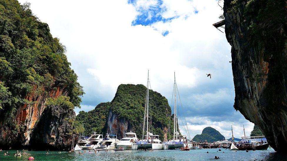 Embracing sanuk by diving off a cliff in Thailand (Credit: Thananuwat Srirasant/Getty)