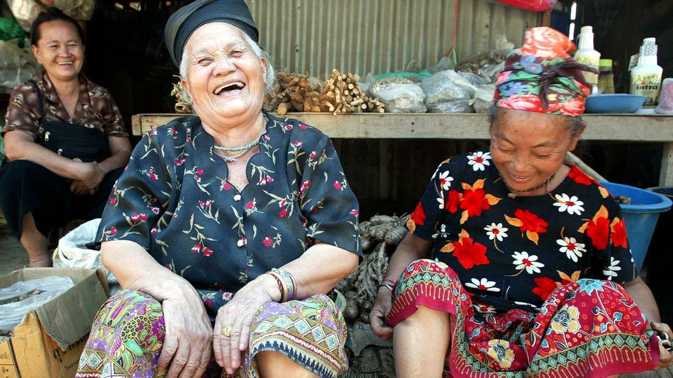 A group of women share a laugh in Thailand (Credit: Pornchai Kittiwongsakul/Getty)
