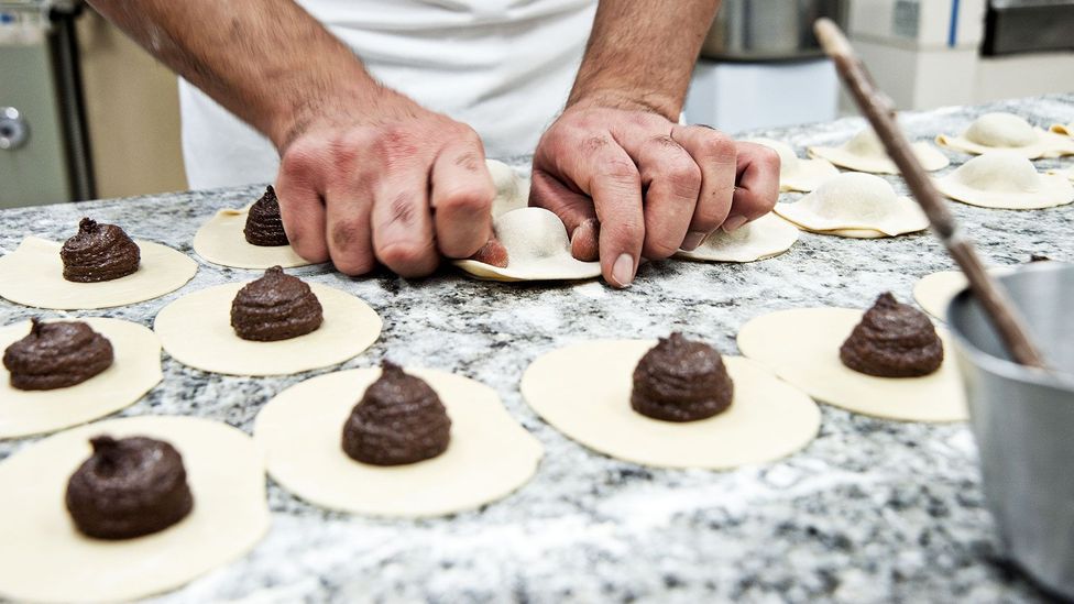 The dough is folded over the chocolate filling into the iconic empanada shape (Credit: Antica Dolceria Bonajuto)