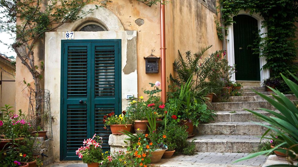 Flowers line the steps of an old Sicilian home (Credit: Thibaut Petit-Bara/Alamy)