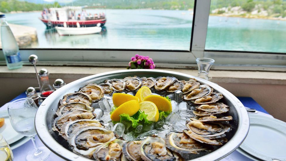 Fresh oysters are served at a waterfront restaurant in Mali Ston (Credit: Gary Blake/Alamy)
