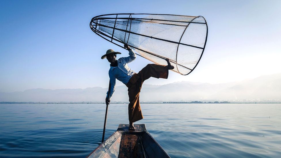 The one-legged rowers exhibit masterful balance on the water (Credit: Dmitry Rukhlenko/Alamy) The one-legged rowers exhibit masterful balance on the water (Credit: Dmitry Rukhlenko/Alamy)