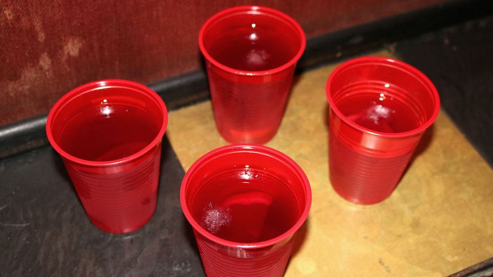 The ruby-red cocktail is served with ice and a lemon wedge (Credit: Nicola Busca) The ruby-red cocktail is served with ice and a lemon wedge (Credit: Nicola Busca)