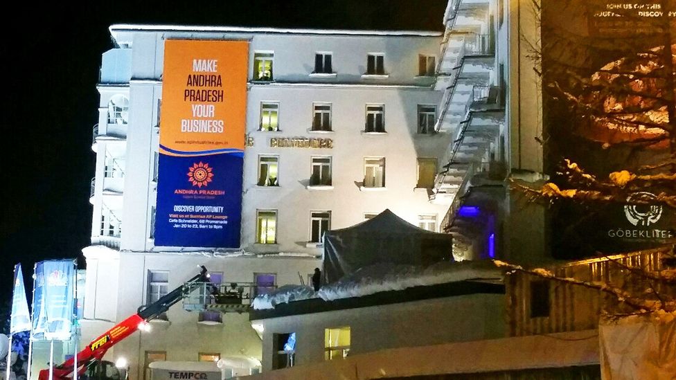 A banner hung at the Belvedere hotel as workers finalise preparations for the WEF annual meeting. Other adverts adorn parts of the exterior of the hotel. (Credit: Lucy Marcus)