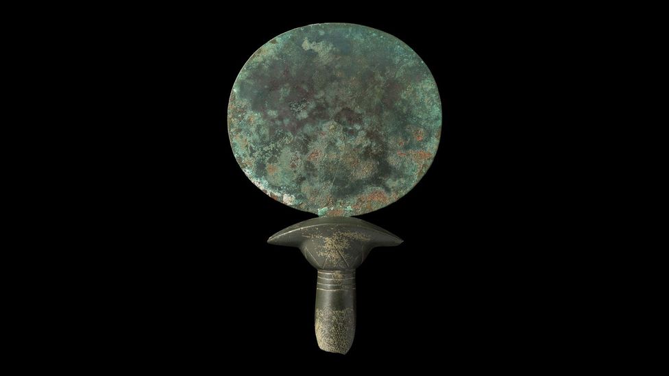 This copper alloy mirror from the 2nd Millennium BC has a handle made out of stone that looks like a column of papyrus (Credit: Courtesy Two Temple Place/Macclesfield Museum)