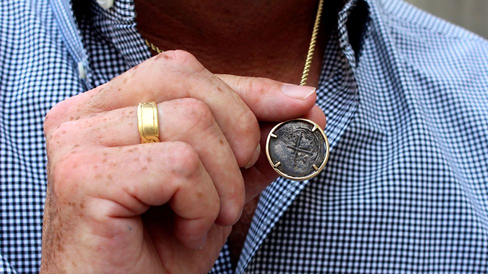 Steve St Amour wears a coin from another shipwreck around his neck (Credit: Chris Baraniuk) Steve St Amour wears a coin from another shipwreck around his neck (Credit: Chris Baraniuk)
