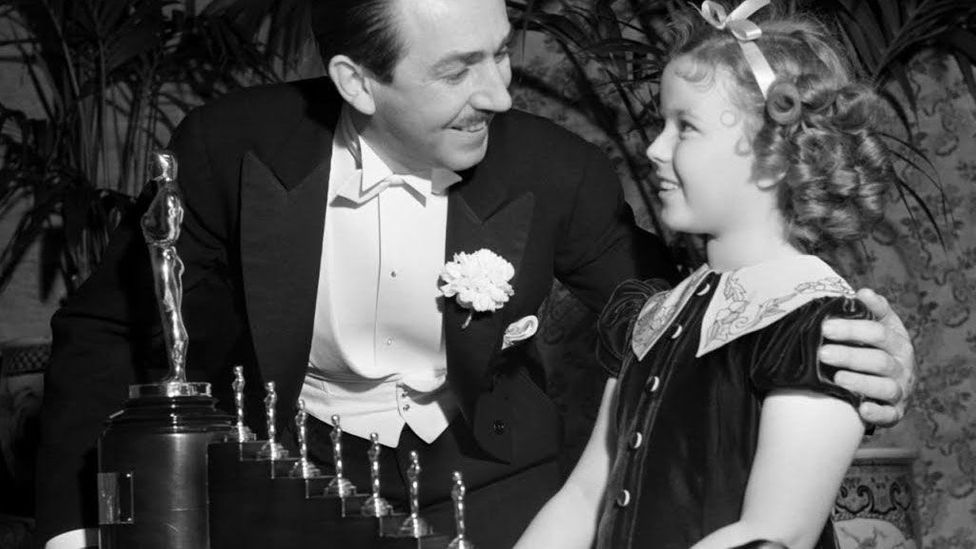 Shirley Temple presented Walt Disney with a special honorary award for Snow White and the Seven Dwarfs that took the form of seven miniature Oscars (Credit: Disney Enterprises) Shirley Temple presented Walt Disney with a special honorary award for Snow White and the Seven Dwarfs that took the form of seven miniature Oscars (Credit: Disney Enterprises)