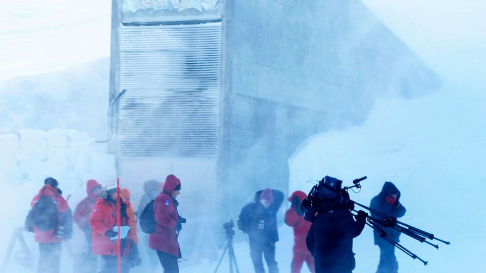 Journalists walk near the entrance of the Svalbard Global Seed Vault (Credit: Larsen, Hakon Mosvold/AFP/Getty)