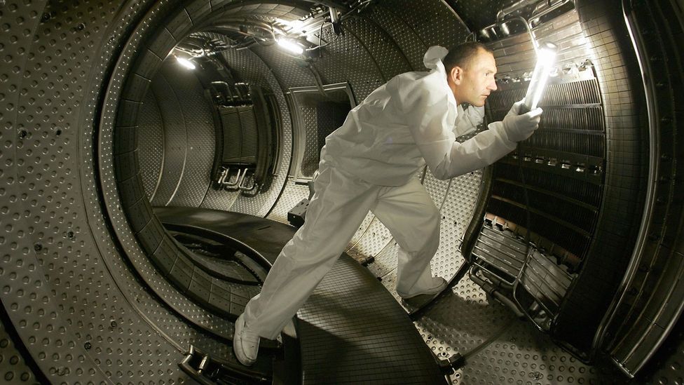A worker inside a plasma heating system in a more traditional government-funded fusion reactor design (Credit: Getty Images)