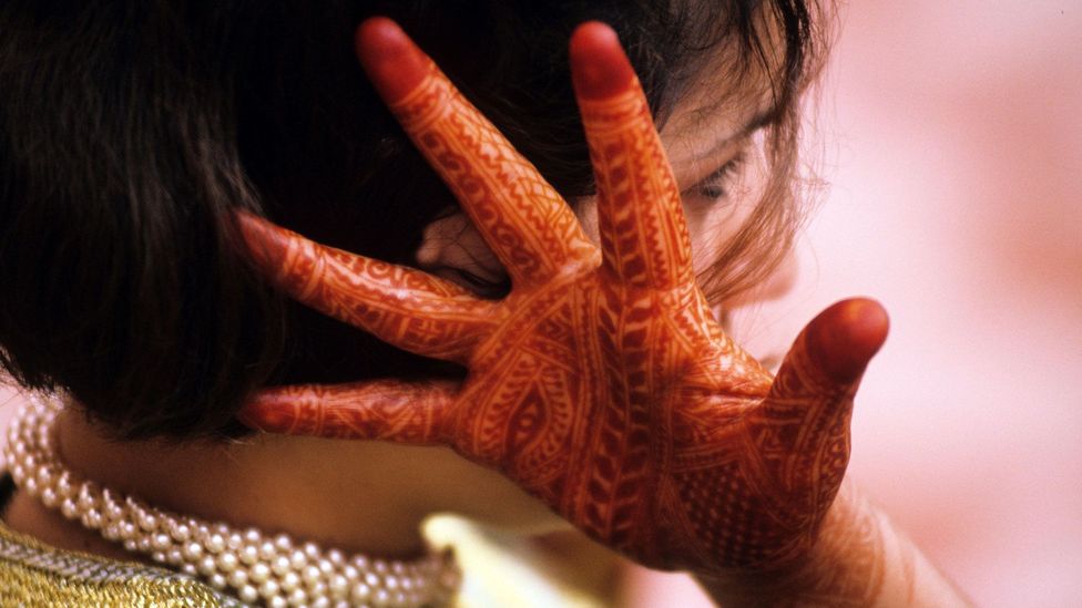 A Moroccan woman's hands are decorated with henna in advance for her wedding (Credit: Simon Russell/Alamy)