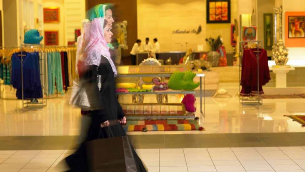 Women shoppers walk past a Louis Vuitton store at the Dubai Mall News  Photo - Getty Images