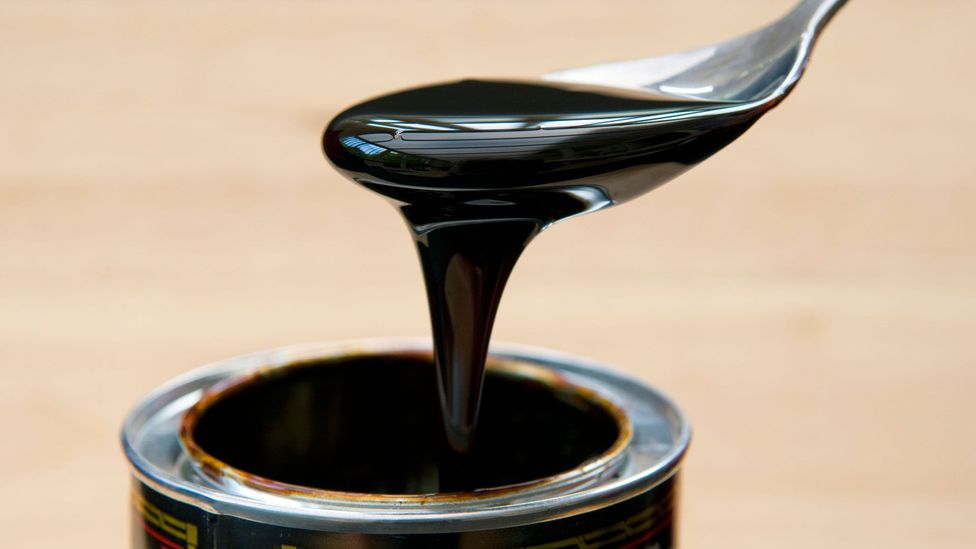 Molasses is the tar-like by-product that emerges when sugar cane is put through a centrifuge (Credit: Getty Images)