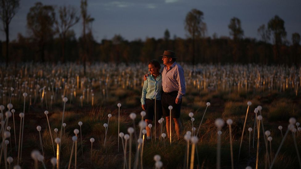 Bruce and Serena Munro stand among the Field of Light's flower-like bulbs (Credit: Mark Pickthall) Bruce and Serena Munro stand among the Field of Light's flower-like bulbs (Credit: Mark Pickthall)