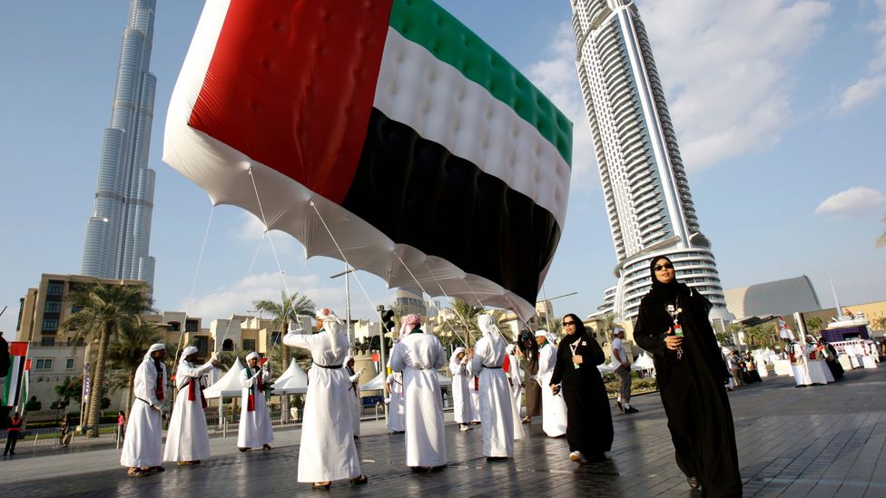 Emirati men and women carry a UAE flag in front of the Burj Khalifa during United Arab Emirates National Day, Dubai (Credit: Getty Images) Emirati men and women carry a UAE flag in front of the Burj Khalifa during United Arab Emirates National Day, Dubai (Credit: Getty Images)