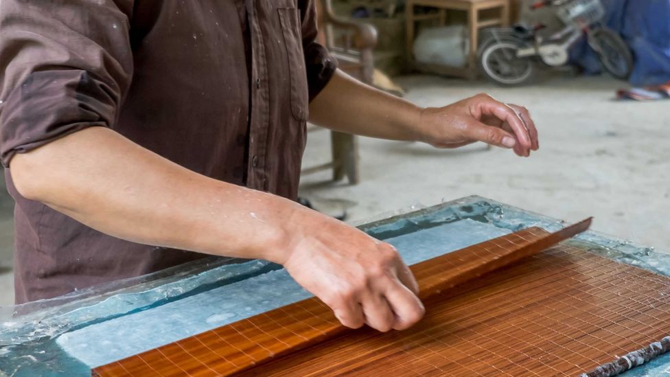 The bamboo mat is used to flatten the first coating of a soon-to-be page (Credit: Kit Yeng Chan)