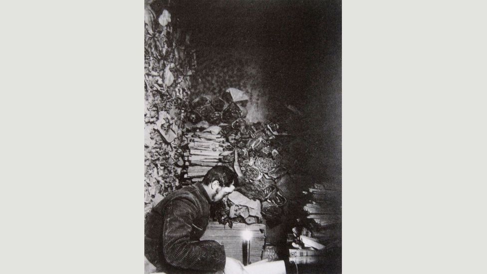 French sinologist Paul Pelliot in the Library Cave at Dunhuang in 1908 reading the manuscripts (Credit: The Musée Guimet)