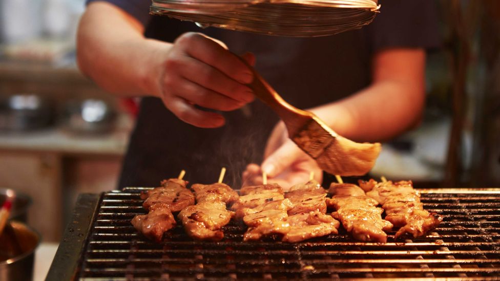 Barbecueing meat at a street food stall in Hong Kong (Credit: Sarah Treleaven)